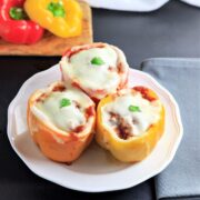 Three sausage and cheese stuffed Italian bell peppers with marinara sauce made in the instant pot.
