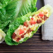 Egg salad bacon and tomato in a lettuce boat.