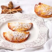 Two pumpkin turnovers with powdered sweetener.