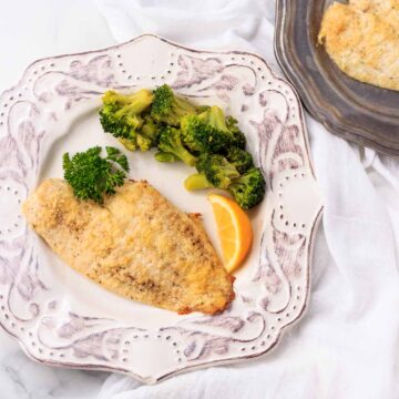 One low carb breaded and crusted fish fillet with broccoli.