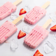 Low carb creamy strawberry creamsicles with sliced berries and ice.
