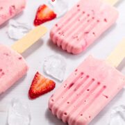 creamy strawberry creamsicles with sliced berries and ice.