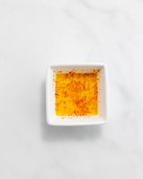 Dissolving saffron in hot water.