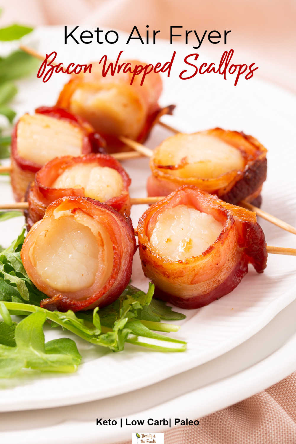 Air Fryer Bacon Wrapped Scallops with baby arugula leaves.